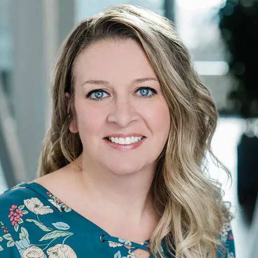 woman with blonde hair and blue eyes and shirt