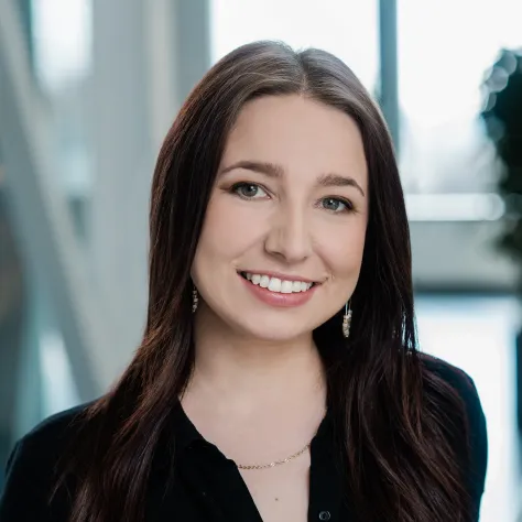 smiling woman with dark brown hair and black shirt